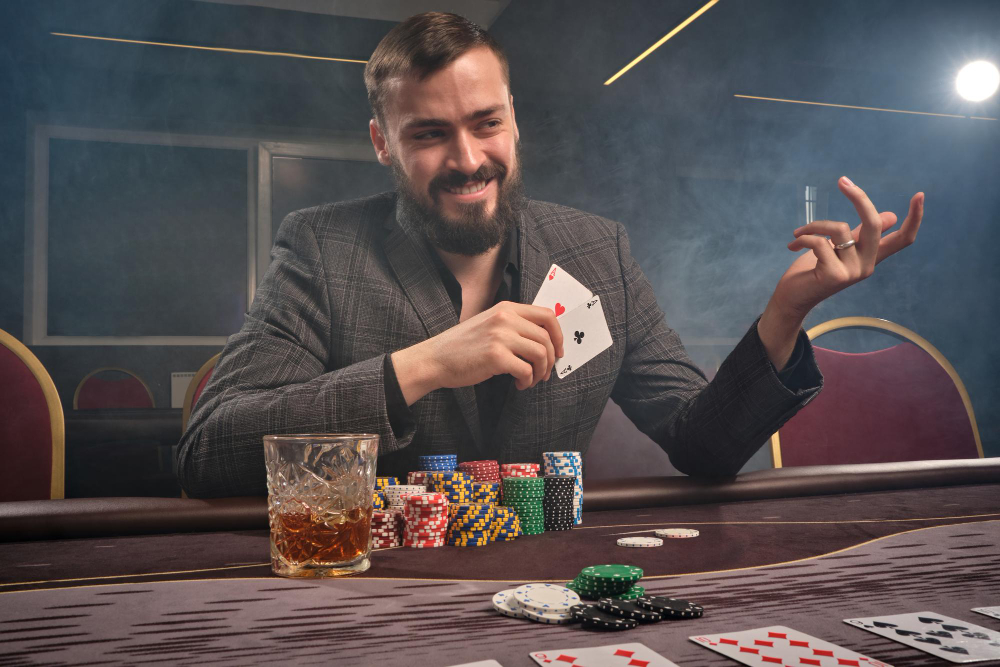 cheeky brunette man classic suit is playing poker sitting table casino smoke he is making bets waiting big win gambling money games fortune