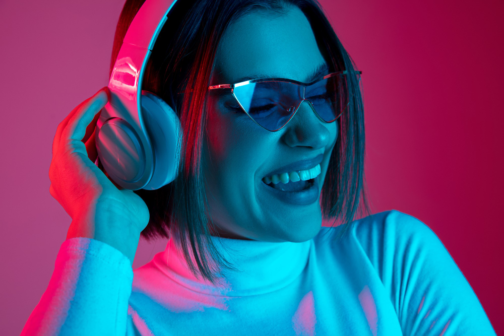 music caucasian woman s portrait pink studio background trendy neon light beautiful female model with headphones concept human emotions facial expression sales ad fashion
